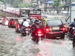 Commuters were seen wading through the waterlogged roads and flooded streets after heavy rainfall pounded Mumbai. Commuters were seen wading through the waterlogged roads and flooded streets after heavy rainfall pounded Mumbai.