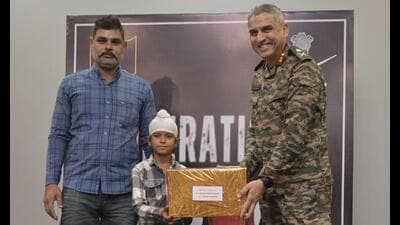 Major General Ranjit Singh Manral, GOC, 7th Infantry Division, felicitating Shravan Singh in Ferozepur. (HT photo)
