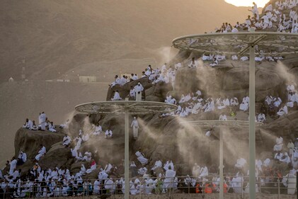Water mist being sprayed on Muslim pilgrims as they prayed on the rocky hill known as the Mountain of Mercy, on the Plain of Arafat, during the annual Hajj pilgrimage, near the holy city of Mecca, Saudi Arabia, on June 27, 2023. (AP Photo/Amr Nabil, File) Water mist being sprayed on Muslim pilgrims as they prayed on the rocky hill known as the Mountain of Mercy, on the Plain of Arafat, during the annual Hajj pilgrimage, near the holy city of Mecca, Saudi Arabia, on June 27, 2023. (AP Photo/Amr Nabil, File)
