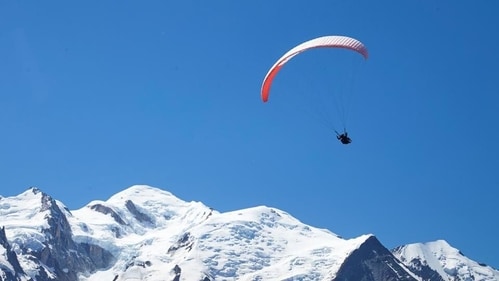 A paraglider flies over the Mont-Blanc mountain from Le Brevent in Chamonix, France, July 20, 2020. (REUTERS) A paraglider flies over the Mont-Blanc mountain from Le Brevent in Chamonix, France, July 20, 2020. (REUTERS)