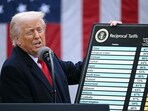 US President Donald Trump holds a chart as he delivers remarks on reciprocal tariffs during an event in the Rose Garden entitled "Make America Wealthy Again" at the White House in Washington, DC, on April 2, 2025. 