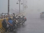 Bike commuters take cover on the side of a road amid heavy rainfall, in Ghaziabad, Uttar Pradesh. Bike commuters take cover on the side of a road amid heavy rainfall, in Ghaziabad, Uttar Pradesh.