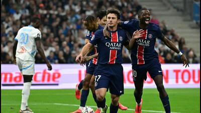 Paris Saint-Germain's midfielder Joao Neves (L) celebrates with Ousmane Dembele (R) after scoring against Olympique de Marseille (OM). (AFP)
