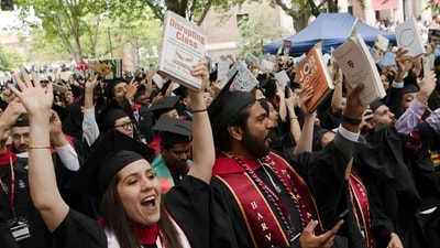 CAMBRIDGE, MASSACHUSETTS - MAY 29: Graduates from Harvard Graduate School of Education celebrate during their commencement ceremony on May 29, 2025 in Cambridge, Massachusetts. The joyous occasion unfolds amid escalating tensions between Harvard and the Trump administration, which has ordered the cancellation of federal contracts valued at approximately $100 million. Libby O'Neill/Getty Images/AFP (Photo by Libby O'Neill / GETTY IMAGES NORTH AMERICA / Getty Images via AFP) (Getty Images via AFP) CAMBRIDGE, MASSACHUSETTS - MAY 29: Graduates from Harvard Graduate School of Education celebrate during their commencement ceremony on May 29, 2025 in Cambridge, Massachusetts. The joyous occasion unfolds amid escalating tensions between Harvard and the Trump administration, which has ordered the cancellation of federal contracts valued at approximately $100 million. Libby O'Neill/Getty Images/AFP (Photo by Libby O'Neill / GETTY IMAGES NORTH AMERICA / Getty Images via AFP) (Getty Images via AFP)