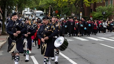 CAMBRIDGE, MASSACHUSETTS - MAY 29: Graduates from the Harvard Kennedy School are led by the Boston Police Gaelic Column of Pipes and Drums through the streets of Harvard Square toward Harvard Yard during commencement ceremonies on May 29, 2025 in Cambridge, Massachusetts. The joyous occasion unfolds amid escalating tensions between Harvard and the Trump administration, which has ordered the cancellation of federal contracts valued at approximately $100 million. Libby O'Neill/Getty Images/AFP (Photo by Libby O'Neill / GETTY IMAGES NORTH AMERICA / Getty Images via AFP) (Getty Images via AFP) CAMBRIDGE, MASSACHUSETTS - MAY 29: Graduates from the Harvard Kennedy School are led by the Boston Police Gaelic Column of Pipes and Drums through the streets of Harvard Square toward Harvard Yard during commencement ceremonies on May 29, 2025 in Cambridge, Massachusetts. The joyous occasion unfolds amid escalating tensions between Harvard and the Trump administration, which has ordered the cancellation of federal contracts valued at approximately $100 million. Libby O'Neill/Getty Images/AFP (Photo by Libby O'Neill / GETTY IMAGES NORTH AMERICA / Getty Images via AFP) (Getty Images via AFP)