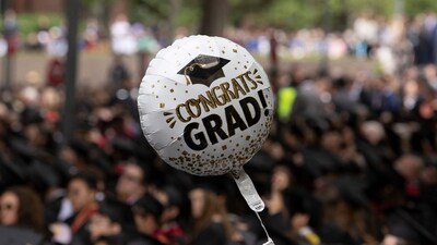 CAMBRIDGE, MASSACHUSETTS - MAY 29: A balloon reading "Congrats Grad" floats above the crowd during Harvard's commencement ceremony on May 29, 2025, in Cambridge, Massachusetts. The joyous occasion unfolds amid escalating tensions between Harvard and the Trump administration, which has ordered the cancellation of federal contracts valued at approximately $100 million. Libby O'Neill/Getty Images/AFP (Photo by Libby O'Neill / GETTY IMAGES NORTH AMERICA / Getty Images via AFP) (Getty Images via AFP) CAMBRIDGE, MASSACHUSETTS - MAY 29: A balloon reading "Congrats Grad" floats above the crowd during Harvard's commencement ceremony on May 29, 2025, in Cambridge, Massachusetts. The joyous occasion unfolds amid escalating tensions between Harvard and the Trump administration, which has ordered the cancellation of federal contracts valued at approximately $100 million. Libby O'Neill/Getty Images/AFP (Photo by Libby O'Neill / GETTY IMAGES NORTH AMERICA / Getty Images via AFP) (Getty Images via AFP)