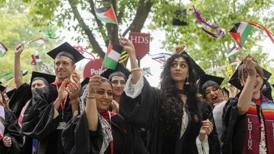 CAMBRIDGE, MASSACHUSETTS - MAY 29: Graduates from Harvard Divinity School celebrate during their commencement ceremony on May 29, 2025 in Cambridge, Massachusetts. The joyous occasion unfolds amid escalating tensions between Harvard and the Trump administration, which has ordered the cancellation of federal contracts valued at approximately $100 million. Libby O'Neill/Getty Images/AFP (Photo by Libby O'Neill / GETTY IMAGES NORTH AMERICA / Getty Images via AFP) (Getty Images via AFP) CAMBRIDGE, MASSACHUSETTS - MAY 29: Graduates from Harvard Divinity School celebrate during their commencement ceremony on May 29, 2025 in Cambridge, Massachusetts. The joyous occasion unfolds amid escalating tensions between Harvard and the Trump administration, which has ordered the cancellation of federal contracts valued at approximately $100 million. Libby O'Neill/Getty Images/AFP (Photo by Libby O'Neill / GETTY IMAGES NORTH AMERICA / Getty Images via AFP) (Getty Images via AFP)