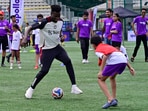 Manchester United player Andre Onana dribbling with football during meet-and-greet session with their fans in Mumbai. 
