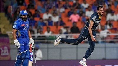 Gujarat Titans' Prasidh Krishna (R) bowls as Mumbai Indians' Rohit Sharma watches during the Indian Premier League (IPL) Twenty20 Eliminator cricket match between Gujarat Titans and Mumbai Indians (AFP) Gujarat Titans' Prasidh Krishna (R) bowls as Mumbai Indians' Rohit Sharma watches during the Indian Premier League (IPL) Twenty20 Eliminator cricket match between Gujarat Titans and Mumbai Indians (AFP)