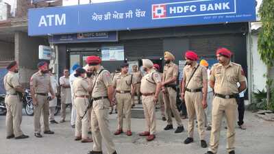Police at the crime spot where three masked men robbed ₹40 lakh from the HDFC Bank branch situated in Rihanna-Jattan village alongside Phagwara-Hoshiarpur road in Kapurthala district on Friday. (HT Photo) Police at the crime spot where three masked men robbed ₹40 lakh from the HDFC Bank branch situated in Rihanna-Jattan village alongside Phagwara-Hoshiarpur road in Kapurthala district on Friday. (HT Photo)