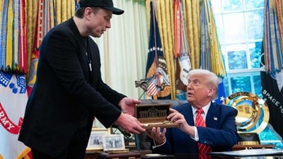 US President Donald Trump gives to Elon Musk a "key to the White House" during a news conference in the Oval Office of the White House in Washington, DC, on May 30, 2025. Musk, who stormed into US politics as President Trump's chainsaw-brandishing sidekick, announced on May 28 that he is leaving his role in US government, intended to reduce federal spending, shortly after his first major break with the President over Trump's signature spending bill. (Photo by Allison ROBBERT / AFP) (AFP) US President Donald Trump gives to Elon Musk a "key to the White House" during a news conference in the Oval Office of the White House in Washington, DC, on May 30, 2025. Musk, who stormed into US politics as President Trump's chainsaw-brandishing sidekick, announced on May 28 that he is leaving his role in US government, intended to reduce federal spending, shortly after his first major break with the President over Trump's signature spending bill. (Photo by Allison ROBBERT / AFP) (AFP)