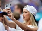 NEW YORK, NEW YORK - MAY 12: Livvy Dunne takes a photograph as she attends a game between the New York Mets and the Pittsburgh Pirates at Citi Field on May 12, 2025 in New York City.   Jim McIsaac/Getty Images/AFP (Photo by Jim McIsaac / GETTY IMAGES NORTH AMERICA / Getty Images via AFP)