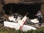 Police officers look at the remains of a crashed plane on the terrace of a residential building in Korschenbroich, Germany, Saturday, May 31, 2025. Police officers look at the remains of a crashed plane on the terrace of a residential building in Korschenbroich, Germany, Saturday, May 31, 2025.