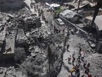 Palestinians inspect the rubble following Israeli strikes on the al-Qattaa family home in al-Tuffah neighbourhood in Gaza City on May 31, 2025. 