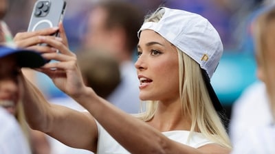 NEW YORK, NEW YORK - MAY 12: Livvy Dunne takes a photograph as she attends a game between the New York Mets and the Pittsburgh Pirates at Citi Field on May 12, 2025 in New York City.   Jim McIsaac/Getty Images/AFP (Photo by Jim McIsaac / GETTY IMAGES NORTH AMERICA / Getty Images via AFP) (Getty Images via AFP)