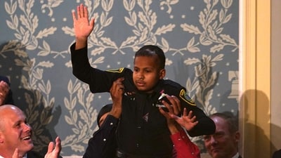 Cancer survivor Devarjaye "DJ" Daniel, 13, waves as he is lifted up while being recognized by US President Donald Trump during his address to a joint session of Congress at the US Capitol in Washington, DC, on March 4, 2025. (Photo by ALLISON ROBBERT / AFP) (AFP) Cancer survivor Devarjaye "DJ" Daniel, 13, waves as he is lifted up while being recognized by US President Donald Trump during his address to a joint session of Congress at the US Capitol in Washington, DC, on March 4, 2025. (Photo by ALLISON ROBBERT / AFP) (AFP)