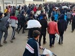 Displaced Palestinians, some carrying sacks of food, leave a distribution centre in Rafah, Displaced Palestinians, some carrying sacks of food, leave a distribution centre in Rafah,