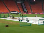 Groundsmen cover the pitch with covers during a practice session ahead of PBKS vs MI in Ahmedabad. Groundsmen cover the pitch with covers during a practice session ahead of PBKS vs MI in Ahmedabad.