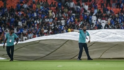 Ground staff cover the pitch as it rains before the start of the Indian Premier League (IPL) Twenty20 second Qualifier cricket match between Punjab Kings and Mumbai Indians (AFP) Ground staff cover the pitch as it rains before the start of the Indian Premier League (IPL) Twenty20 second Qualifier cricket match between Punjab Kings and Mumbai Indians (AFP)