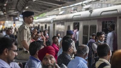 Mumbai, India - June 24, 2021: RPF officer seated on a watch tower keeps vigil on all the movements of commuters, at Dadar station, in Mumbai, India, on Friday, June 24, 2021. (Photo by Pratik Chorge/Hindustan Times) (Pratik Chorge/HT PHOTO) Mumbai, India - June 24, 2021: RPF officer seated on a watch tower keeps vigil on all the movements of commuters, at Dadar station, in Mumbai, India, on Friday, June 24, 2021. (Photo by Pratik Chorge/Hindustan Times) (Pratik Chorge/HT PHOTO)