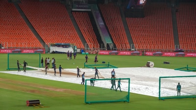Groundsmen cover the pitch with covers during a practice session ahead of PBKS vs MI in Ahmedabad. (PTI) Groundsmen cover the pitch with covers during a practice session ahead of PBKS vs MI in Ahmedabad. (PTI)