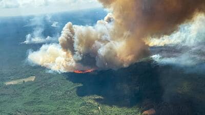 Smoke rises from the Hubert Lake wildfire WWF023, which forced the evacuation of the Hubert Lake Provincial Park area west of Fawcett, Alberta, Canada. (via REUTERS)