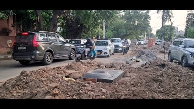 The stretch, which sees heavy vehicular movement, remains partially blocked due to ongoing construction & open pits. (Manish/HT)