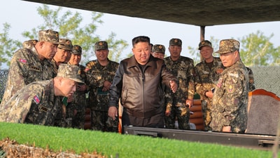 This picture taken on May 29, 2025 shows North Korea's leader Kim Jong Un (C) observing a display by the artillery divisions at an undisclosed location. (AFP)