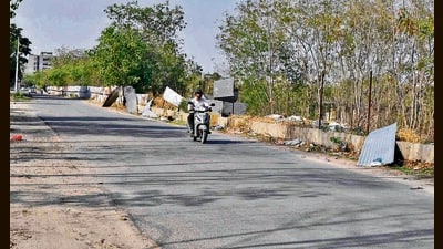 A few barricades and sheets were put up six months ago, but most have since either gone missing or been damaged, exposing commuters to open pits and construction debris. (Manish/HT) A few barricades and sheets were put up six months ago, but most have since either gone missing or been damaged, exposing commuters to open pits and construction debris. (Manish/HT)
