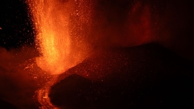 Lava flows during an eruption of the Mount Etna volcano, Sicily, late on May 12, 2025. (Photo by Giuseppe Distefano / Etna Walk / AFP) (AFP) Lava flows during an eruption of the Mount Etna volcano, Sicily, late on May 12, 2025. (Photo by Giuseppe Distefano / Etna Walk / AFP) (AFP)