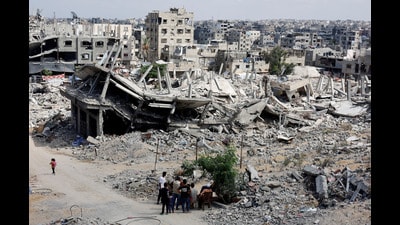 Palestinians next to the rubble of houses destroyed in Israel's military offensive in the Gaza Strip on October 7, 2024. (REUTERS/Mohammed Salem/File Photo)