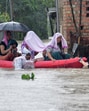 Flood-affected people being moved to safer places through a water-logged road during rains in Imphal East, Manipur, on Monday. (REUTERS)