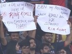 The fans behind the placard, two man who lost their legs, marked the occasion as a personal victory. The fans behind the placard, two man who lost their legs, marked the occasion as a personal victory.