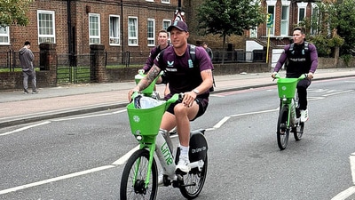 England's Harry Brook, Brydon Carse and Matthew Potts arrive on bicycles before the match (Action Images via Reuters)