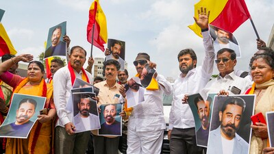Kannada activists hold posters of actor Kamal Haasan during a protest against the latter for his remarks about the Kannada language, in Bengaluru. (PTI)