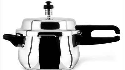 Sleek steel cooker gleams under soft kitchen lights, modern elegance. Sleek steel cooker gleams under soft kitchen lights, modern elegance.