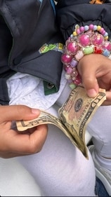 Malti plays with money. Malti plays with money.