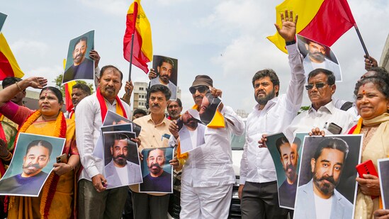 Kannada activists hold posters of actor Kamal Haasan during a protest against the latter for his remarks about the Kannada language, in Bengaluru. (PTI)