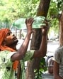 A worker pours water on himself to cool off water during hot weather near Rajghat in New Delhi, India, on May 31. (Hindustan Times)