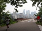 A person runs near the Stone Arch Bridge as a haze from Canadian wildfire smoke causes poor air quality in Minneapolis, Minnesota, U.S., June 3, 2025. 