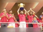 Virat Kohli holds the IPL trophy in front of a packed Chinnaswamy stadium