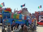 Afghan refugees due for deportation to Afghanistan wait with their belongings outside a holding center near the Pakistan-Afghanistan border in Chaman Afghan refugees due for deportation to Afghanistan wait with their belongings outside a holding center near the Pakistan-Afghanistan border in Chaman