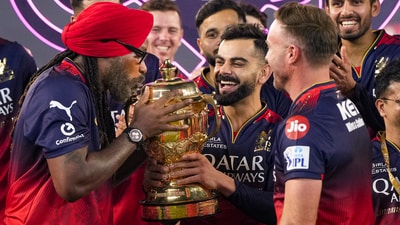 Royal Challengers Bengaluru's Virat Kohli and captain Rajat Patidar with former cricketers Chris Gayle and AB de Villiers and others pose for photographers with the Indian Premier League (IPL) 2025 championship trophy at the Narendra Modi Stadium in Ahmedabad on Tuesday. (PTI) Royal Challengers Bengaluru's Virat Kohli and captain Rajat Patidar with former cricketers Chris Gayle and AB de Villiers and others pose for photographers with the Indian Premier League (IPL) 2025 championship trophy at the Narendra Modi Stadium in Ahmedabad on Tuesday. (PTI)