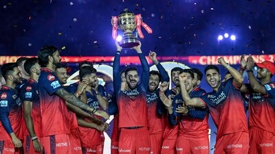 Royal Challengers Bengaluru's Virat Kohli, along with his teammates, celebrates with the trophy after winning the Indian Premier League (IPL) Twenty20 final cricket match against Punjab Kings (AFP) Royal Challengers Bengaluru's Virat Kohli, along with his teammates, celebrates with the trophy after winning the Indian Premier League (IPL) Twenty20 final cricket match against Punjab Kings (AFP)