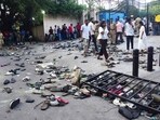 Fans stand next to abandonned shoes and a fallen barrier following a stampede during celebrations, a day after Royal Challengers Bengaluru's victory.