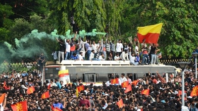 Fans wave flags and let of smoke flares as thousands gather outside the Vidhana Soudha to celebrate Royal Challengers Bengaluru winning the Indian Premier League. (AFP) Fans wave flags and let of smoke flares as thousands gather outside the Vidhana Soudha to celebrate Royal Challengers Bengaluru winning the Indian Premier League. (AFP)