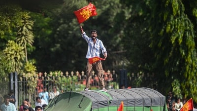 A fan waves a Royal Challengers Bengaluru flag as thousands gather outside the Vidhana Soudha to celebrate their team winning the Indian Premier League. (AFP) A fan waves a Royal Challengers Bengaluru flag as thousands gather outside the Vidhana Soudha to celebrate their team winning the Indian Premier League. (AFP)