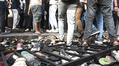 Fans stand next to abandoned shoes and a fallen barrier following a stampede during celebrations. (AFP) Fans stand next to abandoned shoes and a fallen barrier following a stampede during celebrations. (AFP)
