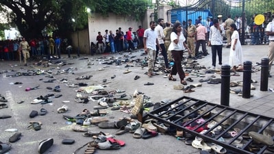 Fans stand next to abandoned shoes and a fallen barrier following a stampede during celebrations. (AFP) Fans stand next to abandoned shoes and a fallen barrier following a stampede during celebrations. (AFP)