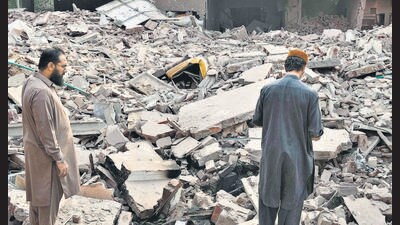 Locals walk through the rubble of a building functioning as a terror training facility targeted by an Indian missile in Muridke town of Pakistan on May 7. (AP) Locals walk through the rubble of a building functioning as a terror training facility targeted by an Indian missile in Muridke town of Pakistan on May 7. (AP)